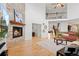 Living room with a stone fireplace, wood floors, and lots of natural light at 9468 E Aspen Hill Ln, Lone Tree, CO 80124
