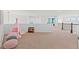 Cozy loft space with a play area, ample natural light, and neutral carpeting, perfect for relaxation and fun at 9468 E Aspen Hill Ln, Lone Tree, CO 80124