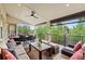 Relaxing covered patio space with comfortable seating, throw pillows, a ceiling fan and outdoor shades at 9468 E Aspen Hill Ln, Lone Tree, CO 80124