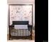 Close up of Bedroom with a black crib and floral wallpaper at 6008 Long Branch Dr, Parker, CO 80134