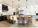 Large kitchen island with seating, modern appliances, and stylish pendant lighting at 6008 Long Branch Dr, Parker, CO 80134