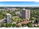 Wide aerial shot of condominium building and surrounding town with mature trees and neighborhood at 3131 E Alameda Ave # 803, Denver, CO 80209