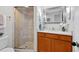 Bright bathroom featuring a glass-enclosed shower, a modern vanity, and a neutral color palette at 3131 E Alameda Ave # 803, Denver, CO 80209