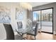 Bright dining room features modern light fixture, glass table, and slider with outside views at 3131 E Alameda Ave # 803, Denver, CO 80209