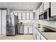 Updated kitchen with stainless steel appliances, white subway tile, and sleek cabinetry at 3131 E Alameda Ave # 803, Denver, CO 80209