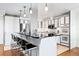 Modern kitchen features a black countertop island with seating and pendant lighting above at 3131 E Alameda Ave # 803, Denver, CO 80209