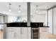 Modern kitchen featuring white cabinets, black countertops, and built-in wine cooler at 3131 E Alameda Ave # 803, Denver, CO 80209