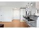 Open-concept living area with breakfast bar and pendant lighting adds an inviting space at 3131 E Alameda Ave # 803, Denver, CO 80209
