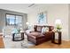 Cozy living room showcasing stylish decor, a comfortable leather sofa, and a sliding glass door at 3131 E Alameda Ave # 803, Denver, CO 80209