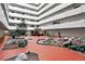 A beautifully landscaped indoor atrium with an indoor water feature and seating areas surrounded by condo balconies above at 3131 E Alameda Ave # 803, Denver, CO 80209