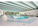 Indoor pool area with clear water, tile flooring, and ample seating for relaxation at 3131 E Alameda Ave # 803, Denver, CO 80209