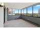 Bright sunroom filled with natural light through a wall of windows with views of the surrounding city at 3131 E Alameda Ave # 803, Denver, CO 80209
