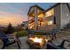 Inviting backyard with a fire pit surrounded by chairs with home exterior and deck at 6766 Mentha Dr, Castle Rock, CO 80108