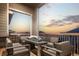 Relaxing balcony with an outdoor fireplace, comfortable seating and scenic sunset views at 6766 Mentha Dr, Castle Rock, CO 80108