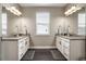 Bathroom with dual vanities, framed mirrors, and modern fixtures at 6766 Mentha Dr, Castle Rock, CO 80108