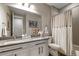 Modern bathroom features a double sink vanity with a shower and a decorative shower curtain at 6766 Mentha Dr, Castle Rock, CO 80108