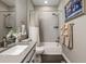 Modern bathroom has a shower over the bathtub with subway tiles and decorative art at 6766 Mentha Dr, Castle Rock, CO 80108