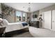 Inviting bedroom featuring an elegant light fixture and beautiful vine decor on the walls at 6766 Mentha Dr, Castle Rock, CO 80108