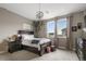 Cozy bedroom with dark wood furniture, comfortable bed, stylish decor, and natural light from the window at 6766 Mentha Dr, Castle Rock, CO 80108