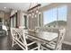 Dining area showcasing a stylish table, bench seating, and large windows with natural light at 6766 Mentha Dr, Castle Rock, CO 80108