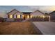 Charming two-story home boasts great curb appeal, neutral paint, stone accents, three-car garage and meticulously manicured lawn at 6766 Mentha Dr, Castle Rock, CO 80108