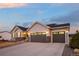 Beautiful home with a two-car garage, a stone accent facade, and a well-manicured lawn at 6766 Mentha Dr, Castle Rock, CO 80108