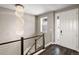 Chic foyer with stylish chandelier, sleek railing, and natural light, creating a grand and inviting entrance at 6766 Mentha Dr, Castle Rock, CO 80108
