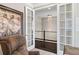 Elegant foyer leads to upper level, showcased by modern chandelier and framed by refined french doors at 6766 Mentha Dr, Castle Rock, CO 80108