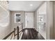 Stunning foyer featuring a modern chandelier, elegant railing, and views into the adjacent living space at 6766 Mentha Dr, Castle Rock, CO 80108