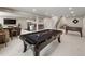 Open-concept basement game room with a pool table, foosball table, and a bar area, perfect for entertaining at 6766 Mentha Dr, Castle Rock, CO 80108
