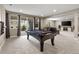 Spacious game room with a pool table, fireplace, recessed lights, and sliding glass doors to the patio at 6766 Mentha Dr, Castle Rock, CO 80108