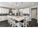 Modern kitchen featuring a large island with seating, stainless steel appliances and sleek countertops at 6766 Mentha Dr, Castle Rock, CO 80108