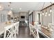 Open-concept living area with a large kitchen island, dining space, and comfortable seating at 6766 Mentha Dr, Castle Rock, CO 80108