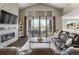 Inviting living room featuring high ceilings, a modern fireplace, large windows and access to outdoor deck at 6766 Mentha Dr, Castle Rock, CO 80108