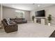 Comfortable living room with plush seating, fireplace, entertainment center, and large windows at 6766 Mentha Dr, Castle Rock, CO 80108