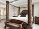 Close-up of bedroom featuring an ornate bed frame, bench seat, and views to the bathroom at 6766 Mentha Dr, Castle Rock, CO 80108