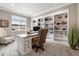 Bright home office with custom built-ins, large window and neutral tones, providing a professional space at 6766 Mentha Dr, Castle Rock, CO 80108