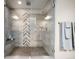 Beautiful shower with a glass door, bench seat, and stylish tiling at 6766 Mentha Dr, Castle Rock, CO 80108