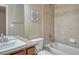 Functional bathroom features granite countertop, tile backsplash, and tub with shower at 15235 W Iliff Ave, Lakewood, CO 80228