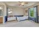 Comfortable bedroom has great natural lighting and a locker-style dresser at 15235 W Iliff Ave, Lakewood, CO 80228
