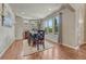 Bright dining room with wood floors, chandelier, large windows with backyard view and space for entertaining at 15235 W Iliff Ave, Lakewood, CO 80228