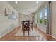 Elegant dining room with hardwood floors, a modern chandelier, and bright windows at 15235 W Iliff Ave, Lakewood, CO 80228