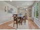 Charming dining room with hardwood floors, a stylish chandelier, and ample natural light at 15235 W Iliff Ave, Lakewood, CO 80228