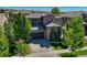 Attractive two-story home with stone accents, a basketball hoop, and mature landscaping at 15235 W Iliff Ave, Lakewood, CO 80228