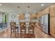 Bright kitchen with wood cabinets, granite countertops, stainless appliances, pendant lights, and bar seating at 15235 W Iliff Ave, Lakewood, CO 80228
