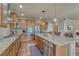 Expansive kitchen with granite countertops, stainless steel appliances, and island with bar seating at 15235 W Iliff Ave, Lakewood, CO 80228