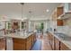 Open kitchen with granite countertops, island seating, and stainless steel appliances, seamlessly connects to the living area at 15235 W Iliff Ave, Lakewood, CO 80228