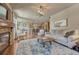 Open living space with fireplace, seamless transition to the kitchen, creating an ideal area for entertaining at 15235 W Iliff Ave, Lakewood, CO 80228