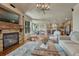 Inviting living room features stone fireplace, hardwood floors, and seamless flow to dining and kitchen areas at 15235 W Iliff Ave, Lakewood, CO 80228