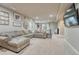 Spacious living room with plush sectional, large windows, and recessed lights at 15235 W Iliff Ave, Lakewood, CO 80228